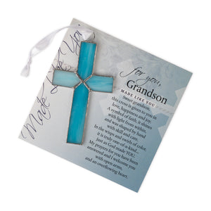 2 of 4:Light blue stained glass cross lying on the 