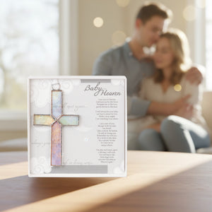 4 of 6:Baby in Heaven memorial gift on a table in the foreground and a grieving couple in the background. 