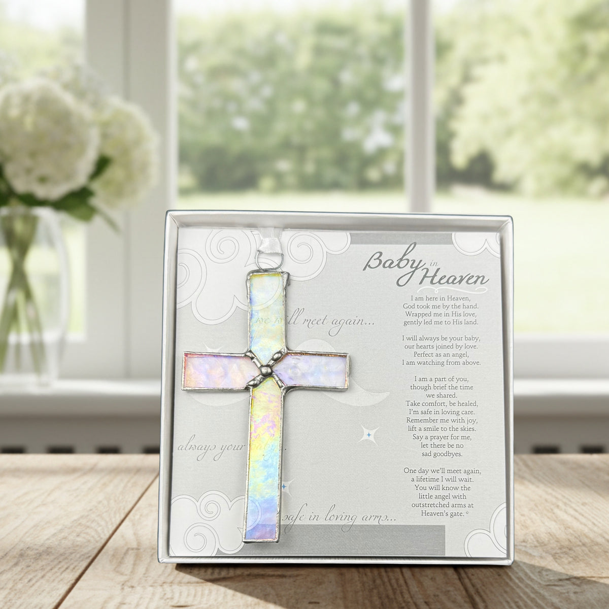 Infant loss poem and stained glass cross on a table.
