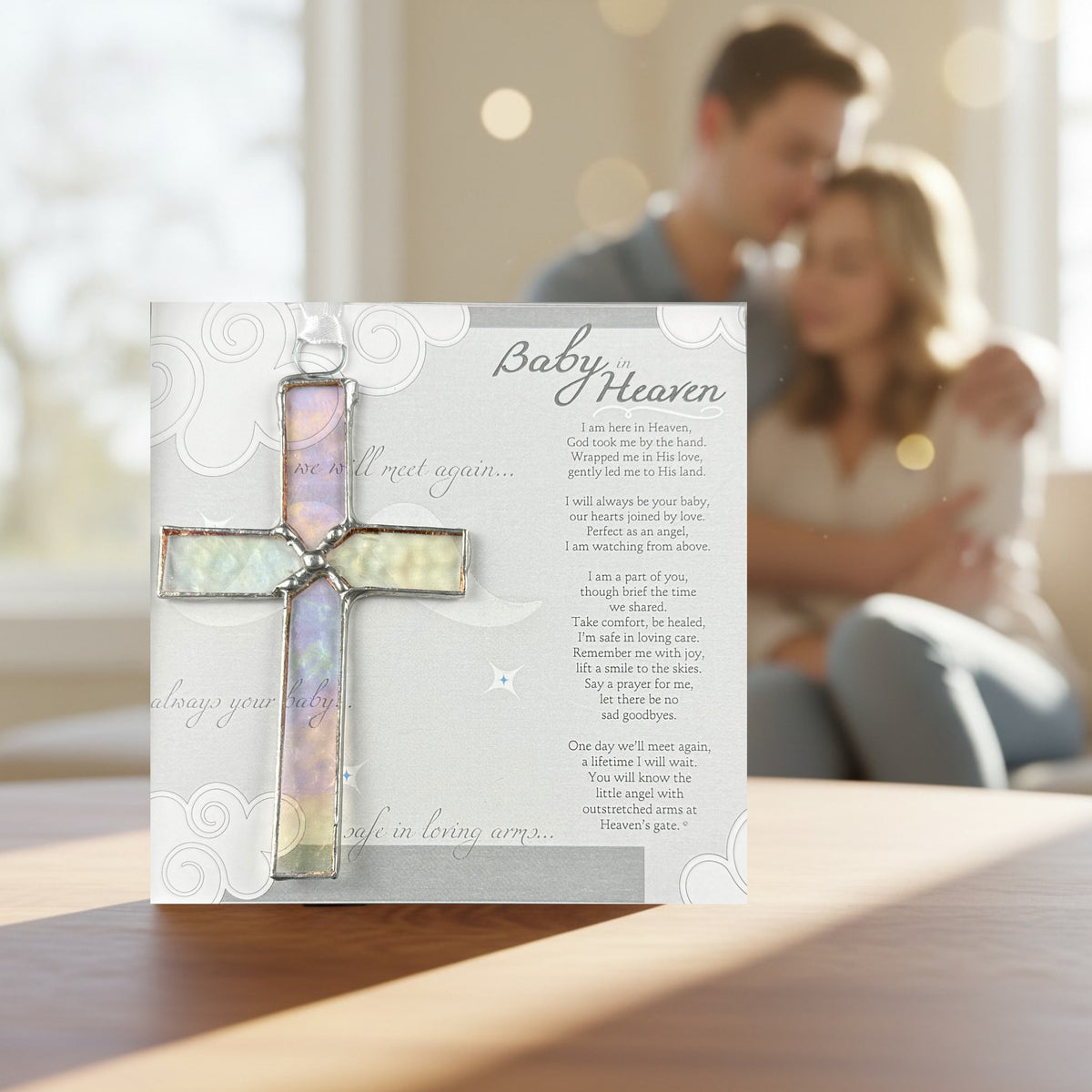 Baby in Heaven memorial gift on a table in the foreground and a grieving couple in the background. 