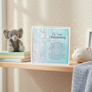 2 of 4:Christening cross gift on a shelf in a baby's room.