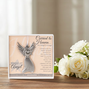 3 of 4:Carried to Heaven gift sitting next to white flowers.