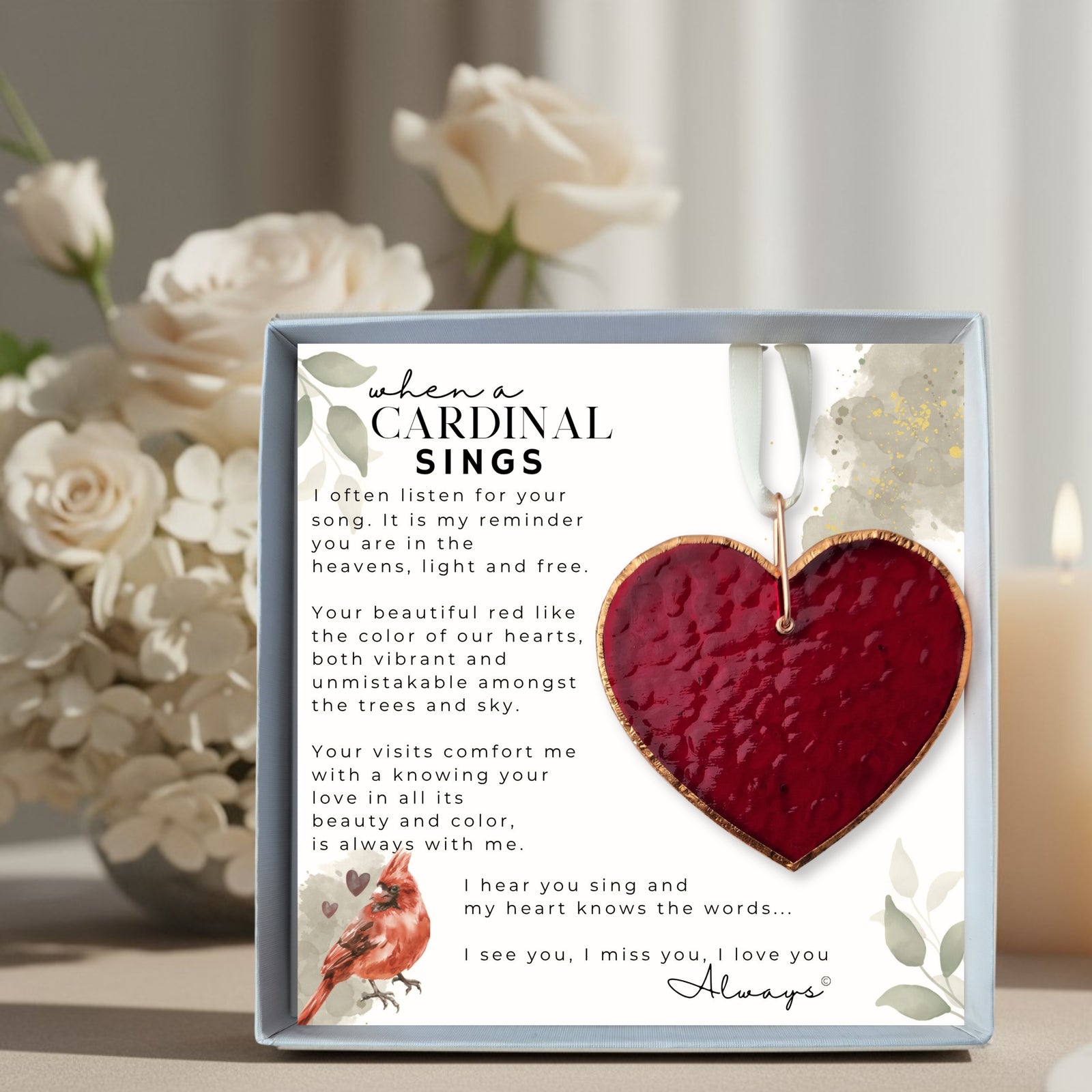 Memorial Gift: Red stained glass heart with copper edging and ring packaged with "When a Cardinal Sings" Poem in a white box with a clear lid.