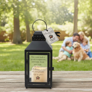 2 of 6:Pawprints Left by You Lantern on a table with a family and their dog in the background.