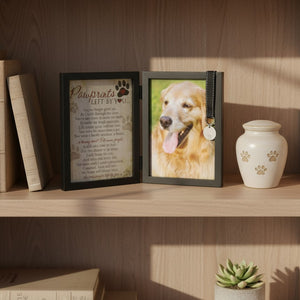 8 of 9:Pawprints Left by You pet memorial frame with photo of a dog and urn on a wooden shelf.