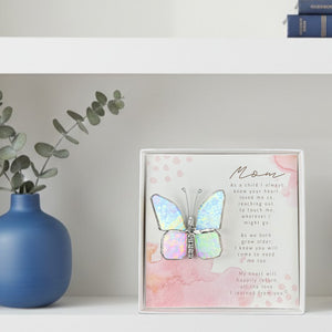 3 of 4:Butterfly gift for mom on a bookshelf.