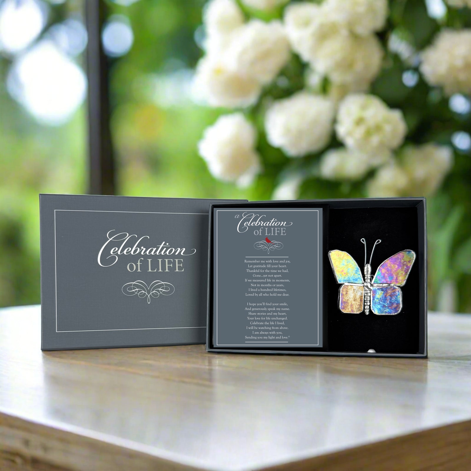 Celebration of Life butterfly in its box with the lid behind it.