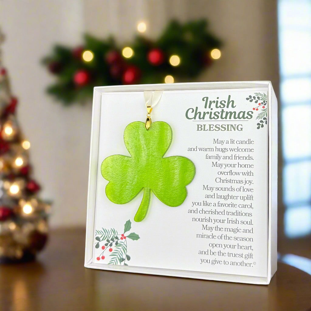 Irish Christmas Blessing and green glass shamrock on a table in a living room decorated for Christmas.