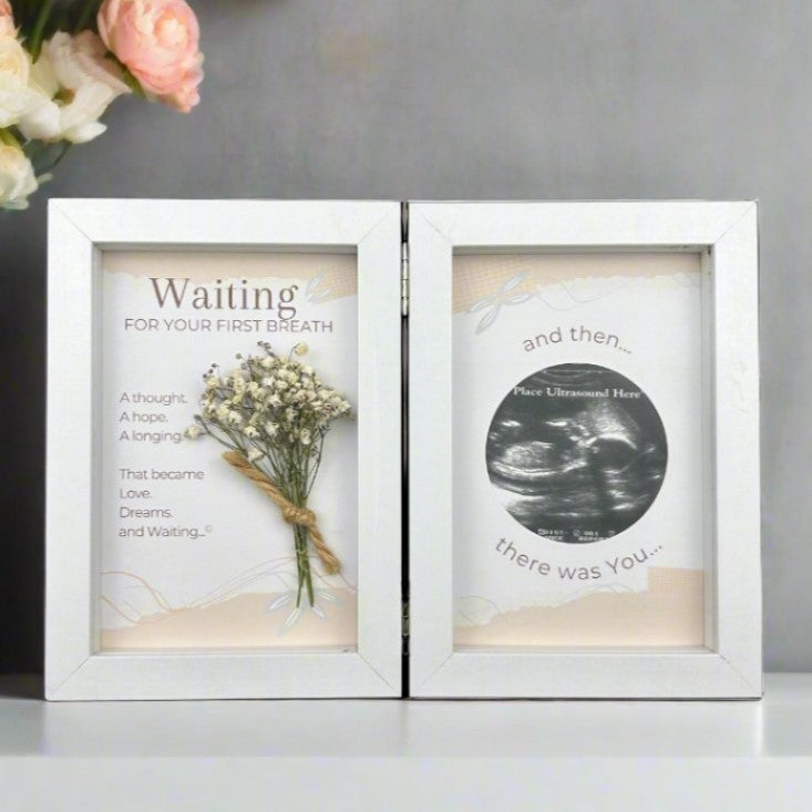 Ultrasound frame with sentiment and dried baby's breath on one side and artwork with a 2 1/2" opening for sonogram photo on the other side.