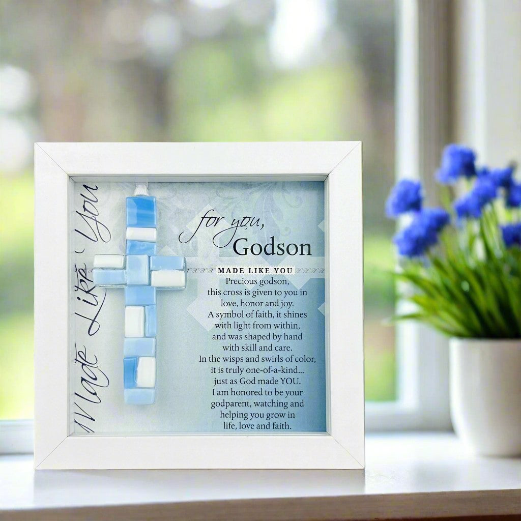 Framed blue mosaic cross with "For you, Godson" Sentiment on a table.