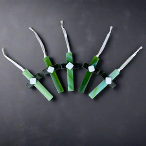 4 of 5:An assortment of green glass crosses showing the unique glass used for each cross.