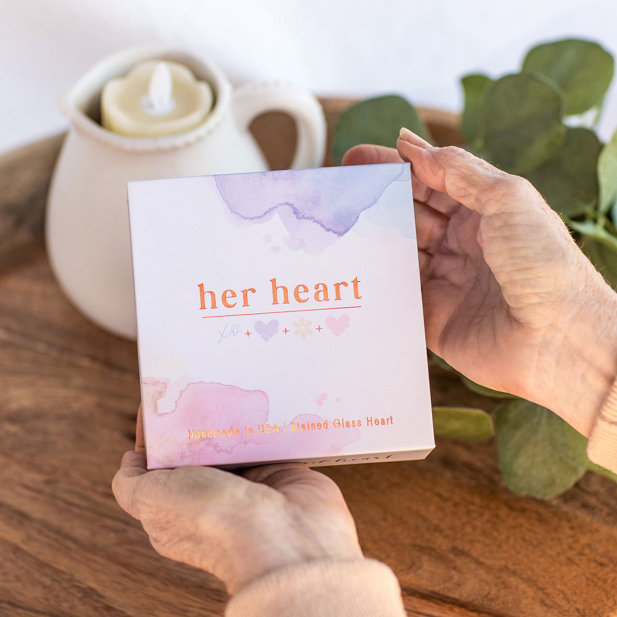 Her Heart gift box being held in hands.