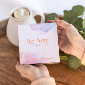 3 of 8:Her Heart gift box being held in hands.