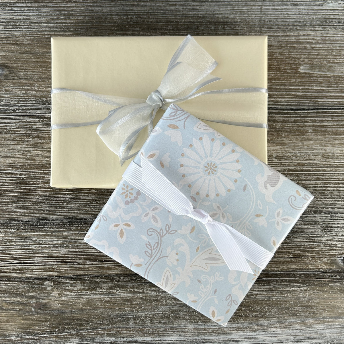 Products wrapped in gift wrap with a fabric bow.