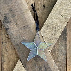 5 of 7:Clear iridescent star with black ribbon for hanging.