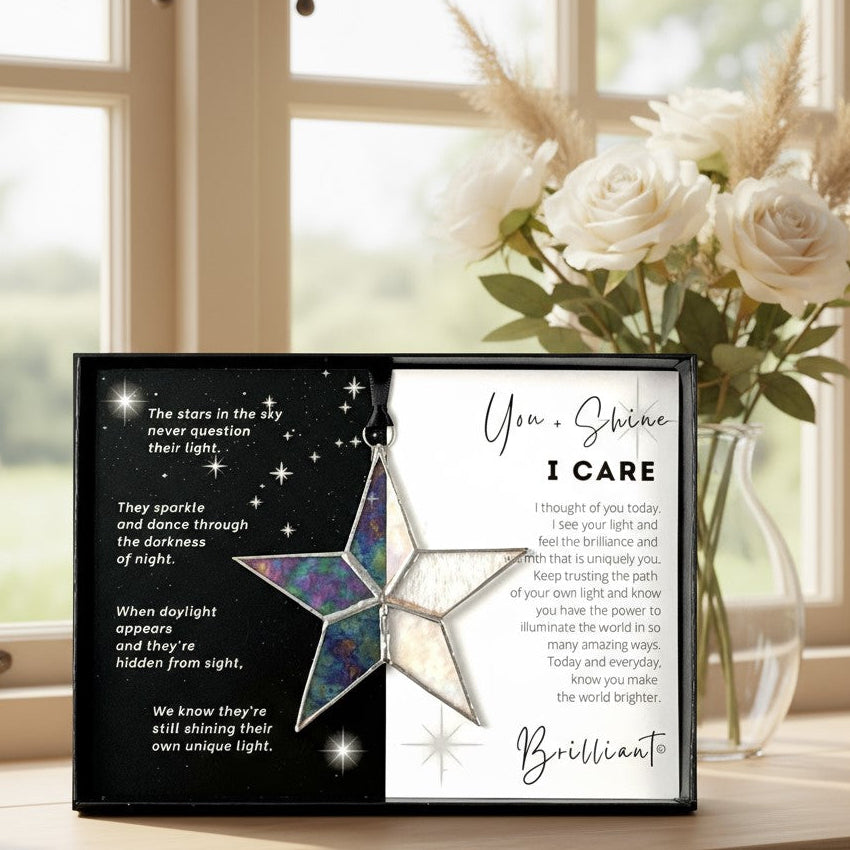Handmade 4" clear iridescent stained glass star with silver edging, packaged with "You + Shine I Care" sentiment in black gift box with clear lid.