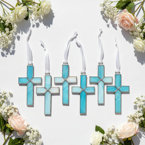 4 of 5:An assortment of light blue stained glass crosses with varying shades of blue glass.