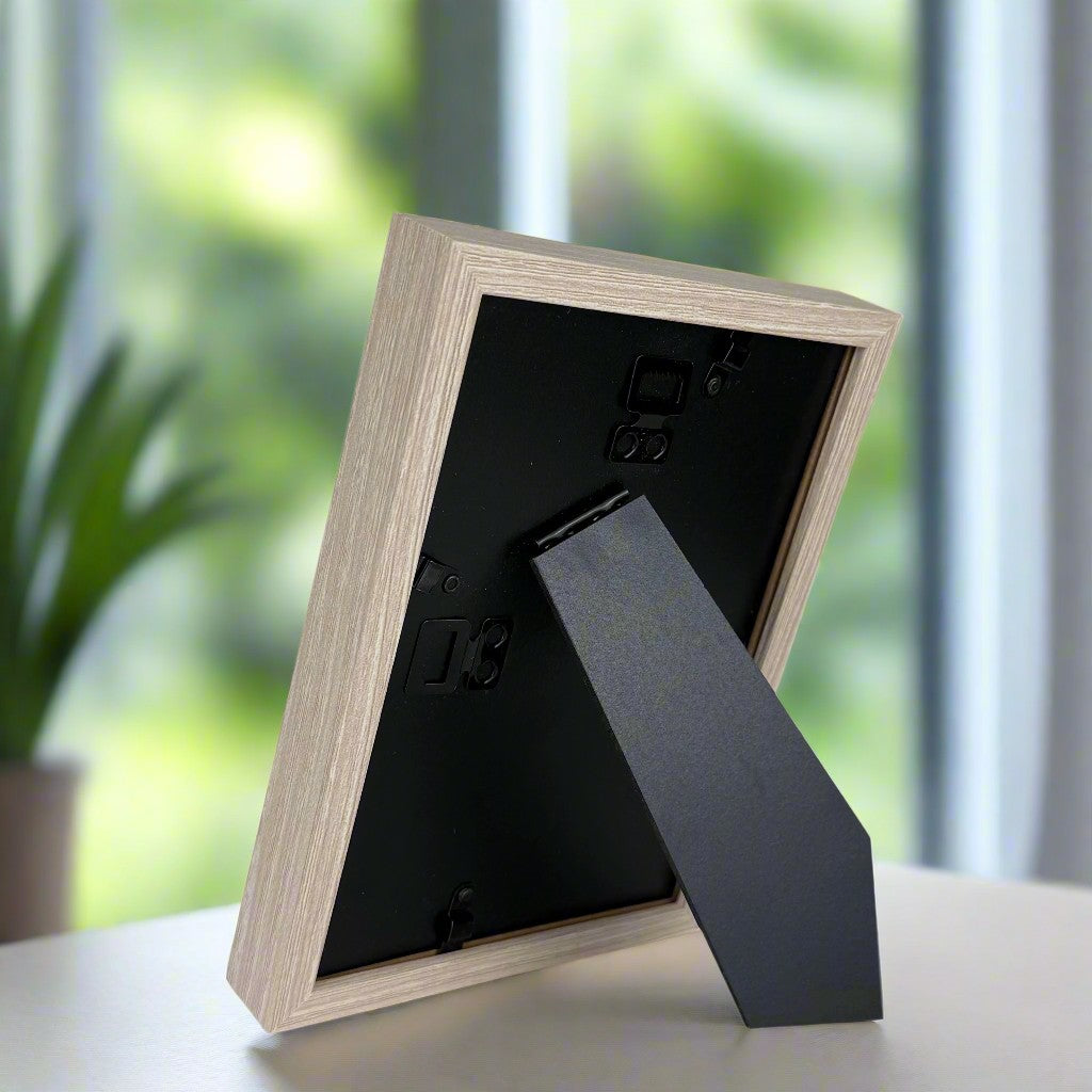 Back of the frame showing easel back and hanging tab.