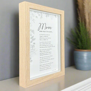 2 of 8:Framed poem for mom on a shelf with a plant in the background.