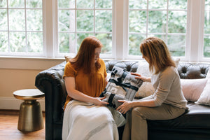 8 of 8:A woman giving the Pawprints blanket to a grieving pet owner.