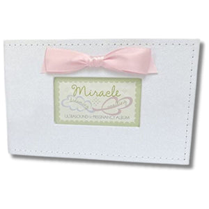 2 of 8:White faux suede photo album with pink satin bow and a window with Miracle sentiment artwork showing.