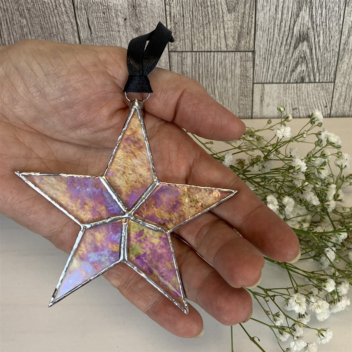 Iridescent star being held in hand.