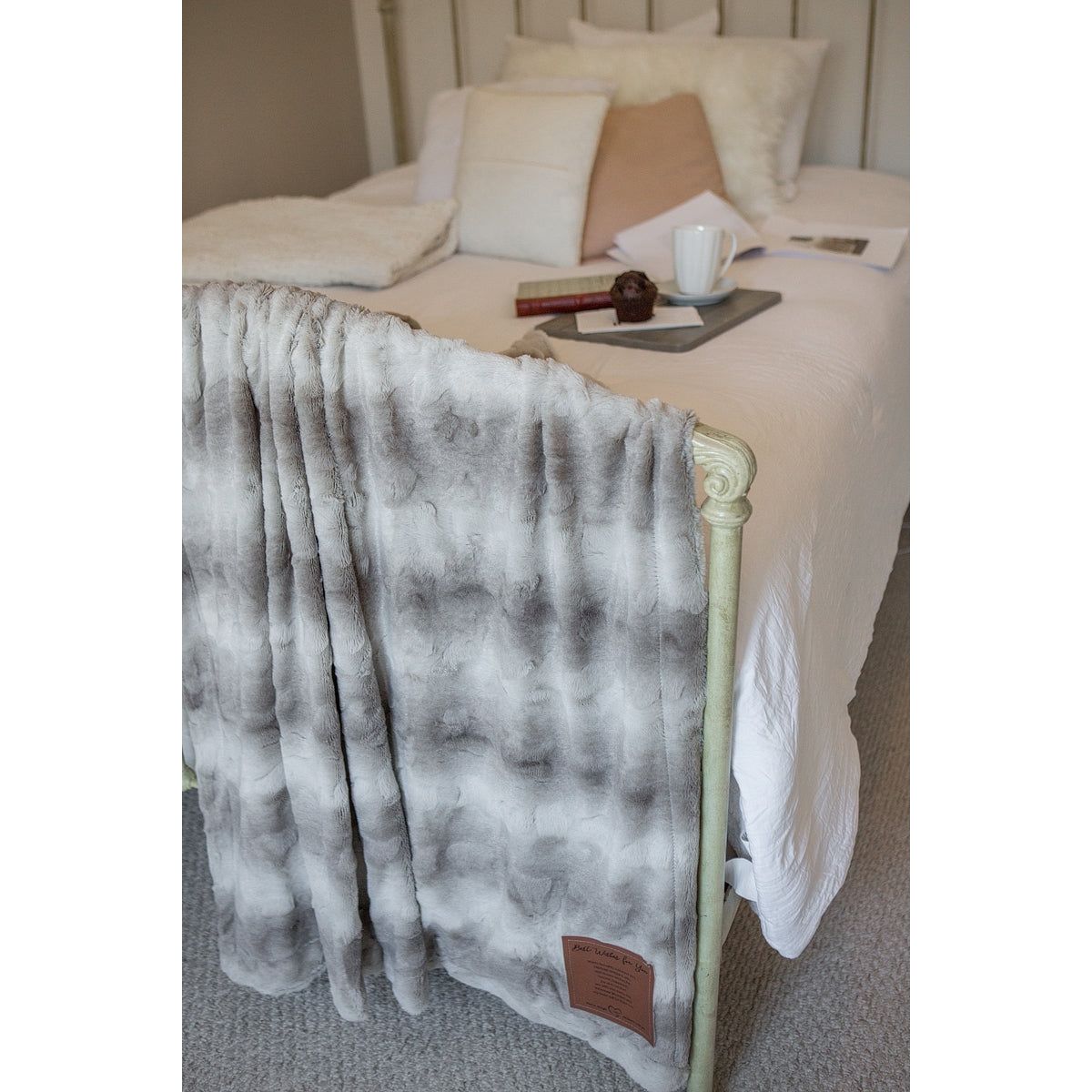 Always with You blanket draped over a footboard showing the soft texture and the varying shades of gray.