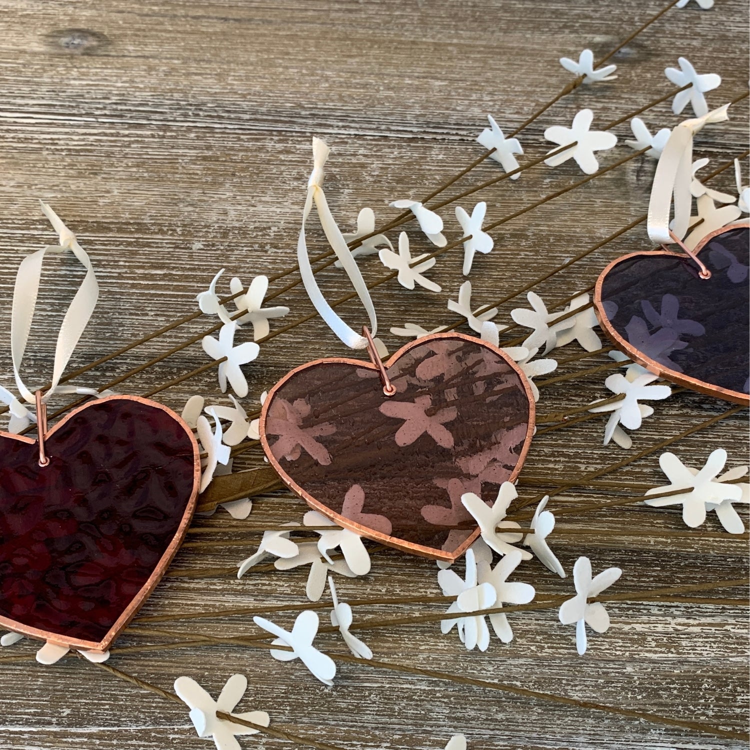 Stained glass hearts on a table - Click to shop all of our handmade gifts