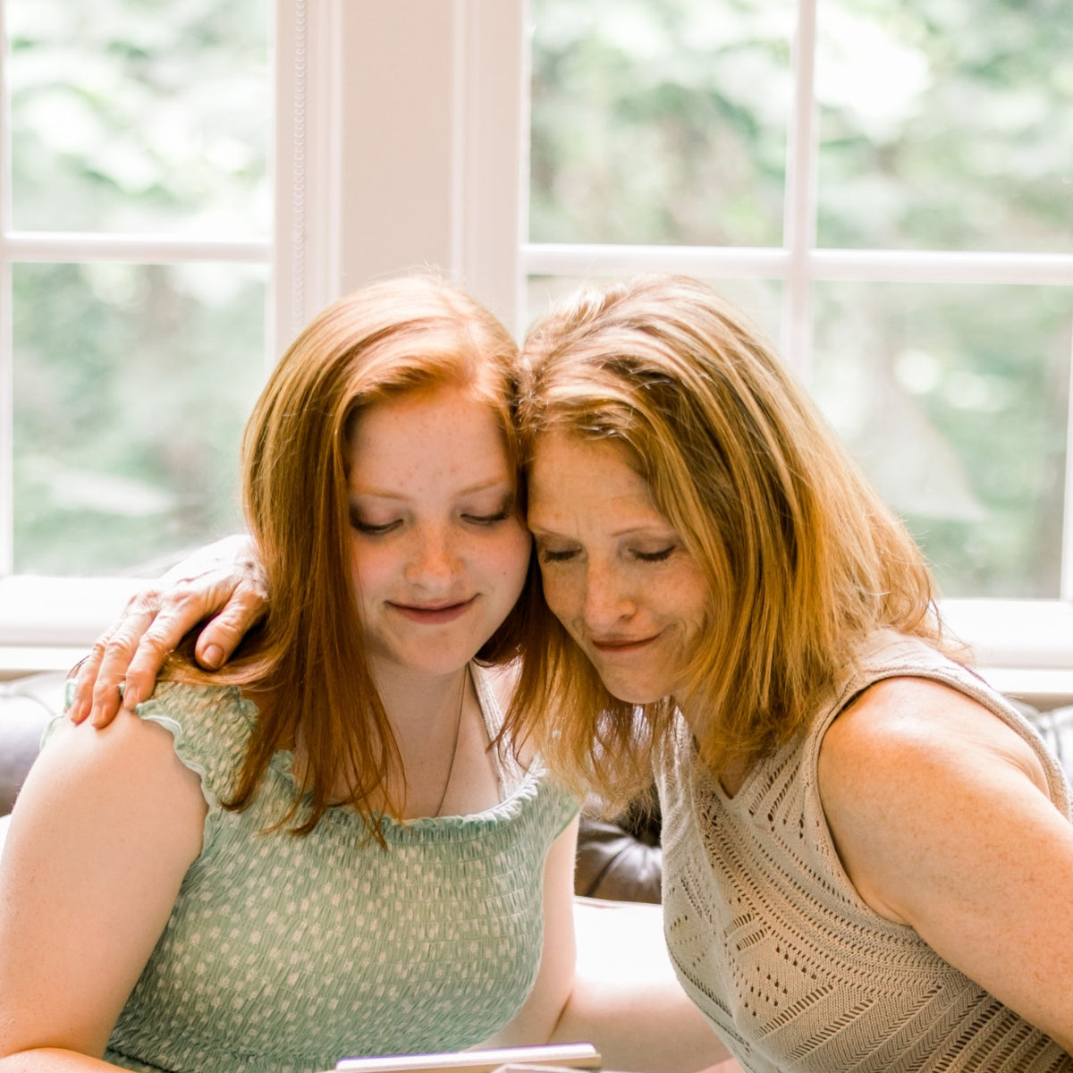 Daughter giving her mother Her Heart for Mom.