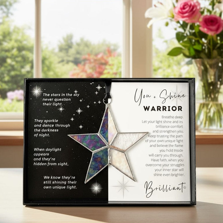 Handmade 4" clear iridescent stained glass star with silver edging, packaged with "You + Shine Warrior" sentiment in black gift box with clear lid.