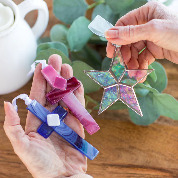 Glass crosses and a glass star being held in hands - Click to shop All Handmade Gifts