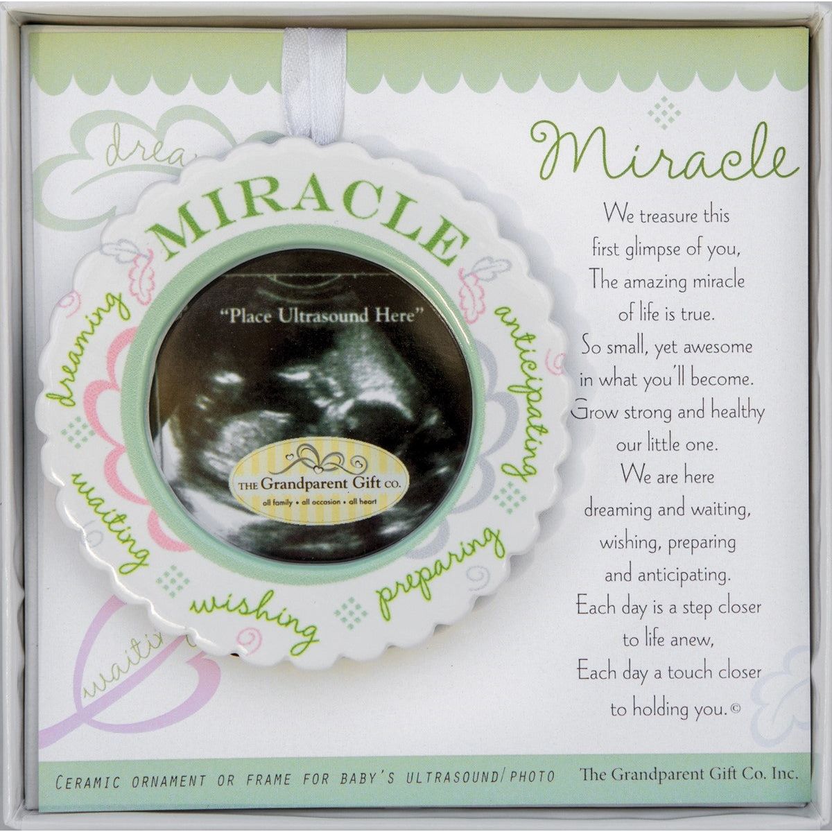 3" scalloped ceramic baby ultrasound ornament to hold 2.25" round sonogram image. Ornament is gift boxed with "Miracle" poem folding card in a white 5.5"x5.5" box with a clear lid.