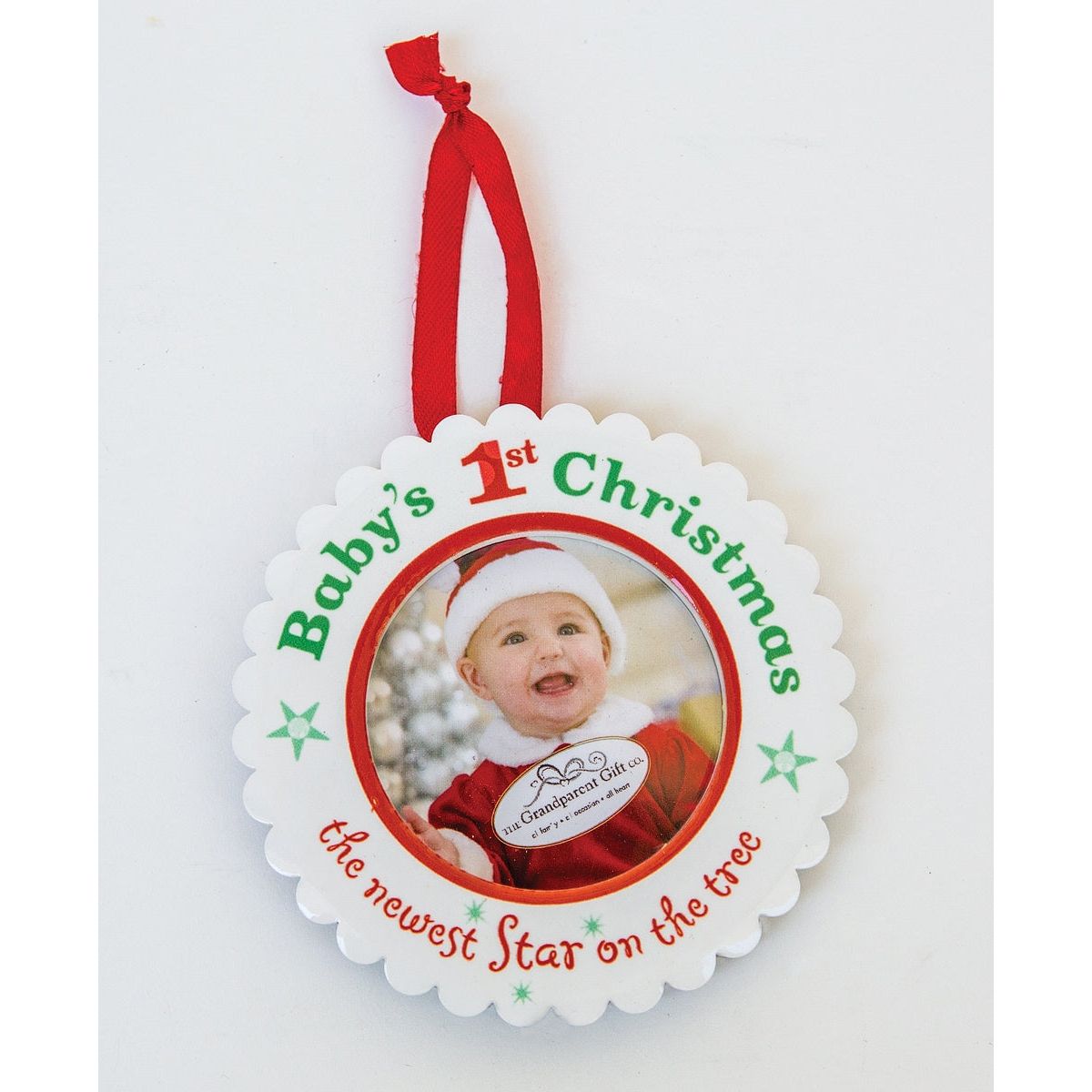 Baby&#39;s 1st Christmas ornament with red ribbon for hanging.
