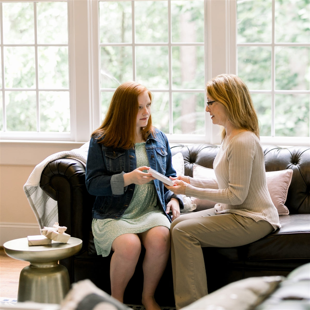 Two women exchanging a gift