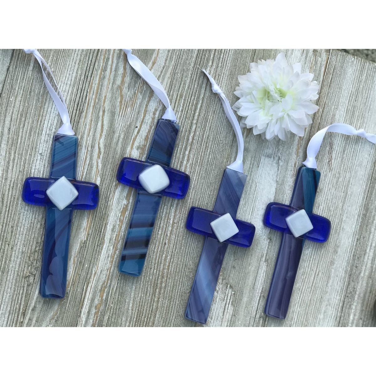 An assortment of blue glass crosses each unique.