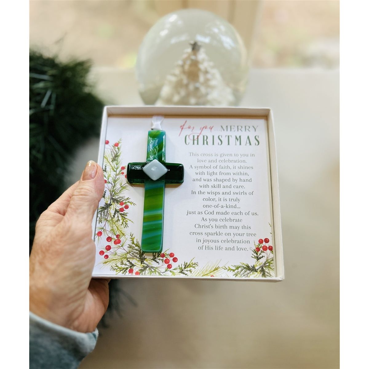 Christmas Cross being held in a hand.