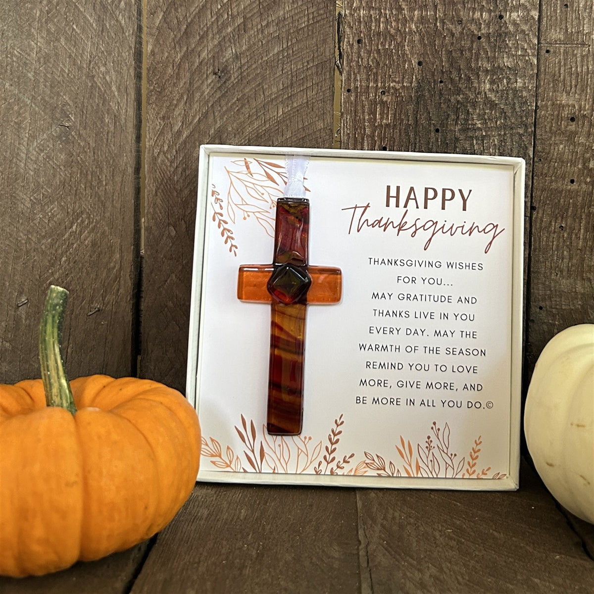 Happy Thanksgiving cross sitting on a bookshelf.