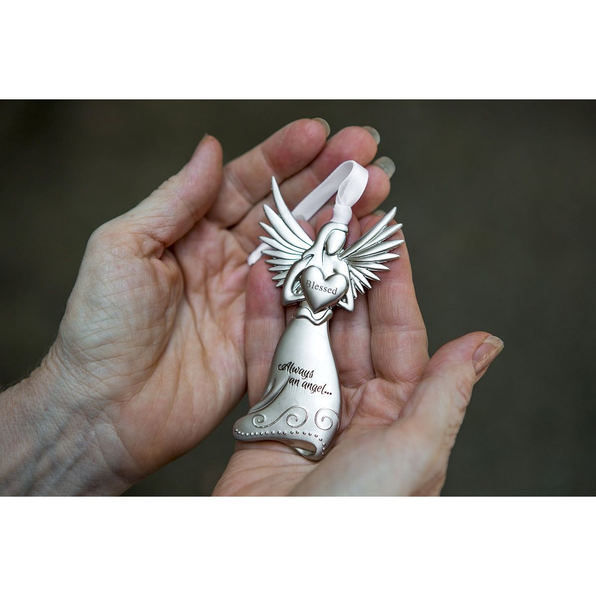Blessed angel being held in the palm of a hand.