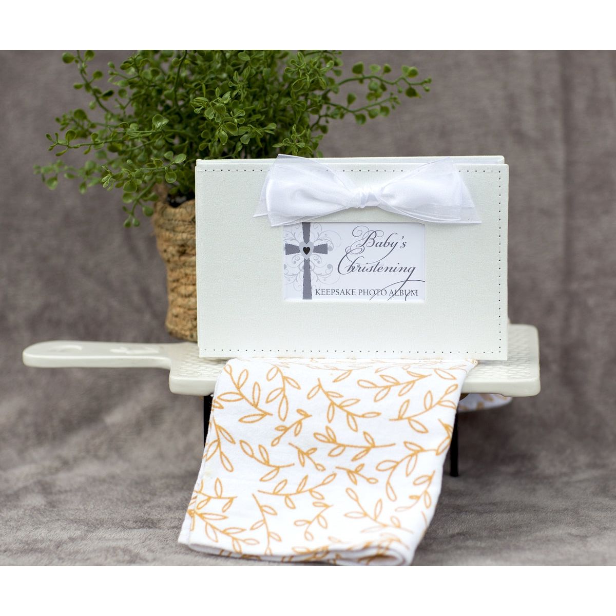 Baby&#39;s Christening photo book in a decorative setting.