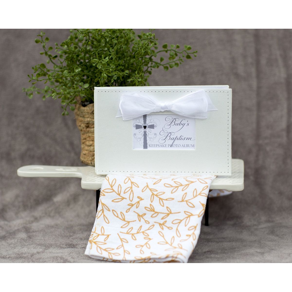 Baby&#39;s Baptism photo book in a decorative setting.