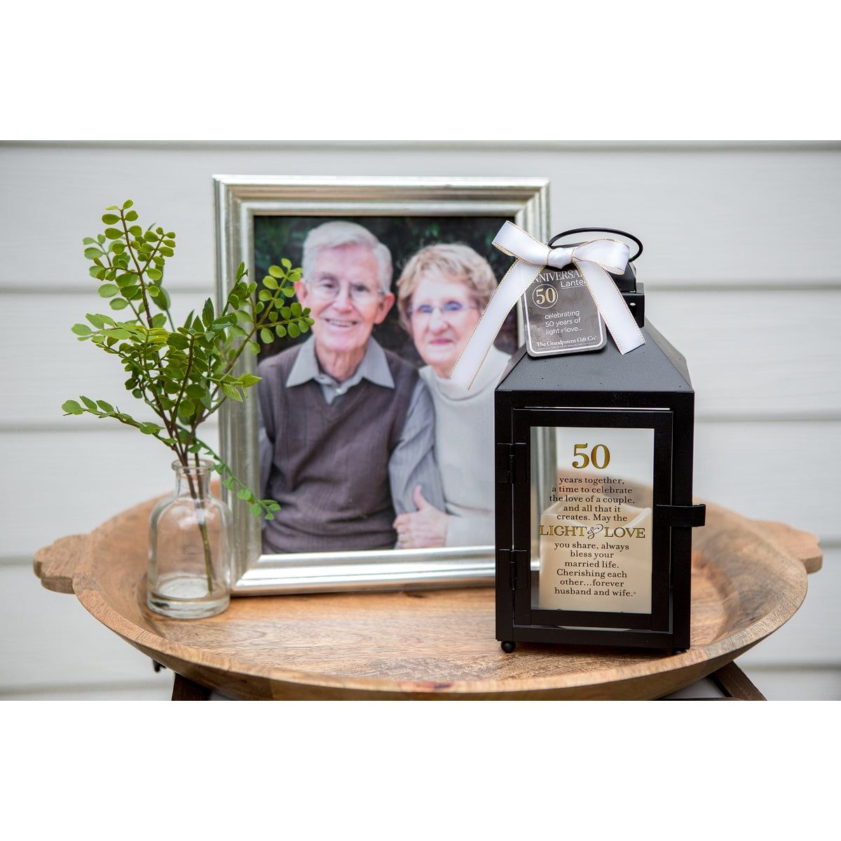 50th Anniversary Lantern in front of a photo of a happy couple.