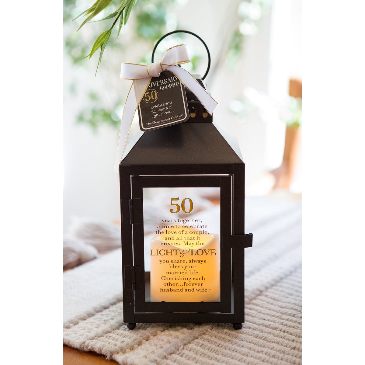 50th Anniversary Lantern with candle lit with a soft glow