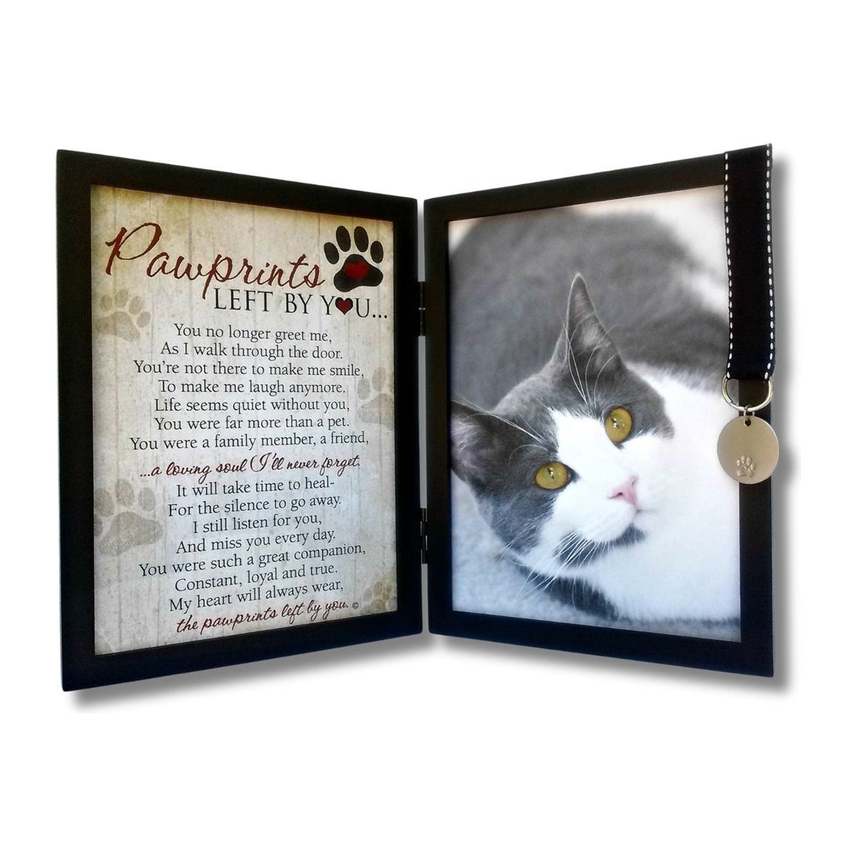 Black 5x7 hinged double frame with "Pawprints Left By You" sentiment on the left and space for a photo on the right. Frame features a black grosgrain ribbon with white stitching that holds a tag with a pawprint.