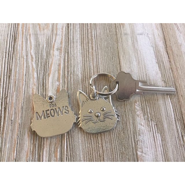 Handmade in the USA pewter keychain with cat face on front and &quot;the MEOWS&quot; on the back.