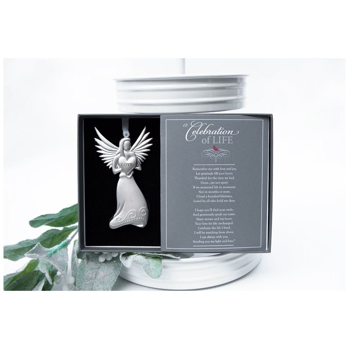 Silver toned metal angel is holding a heart with the word &quot;LOVE&quot; and has a white organza ribbon for hanging.