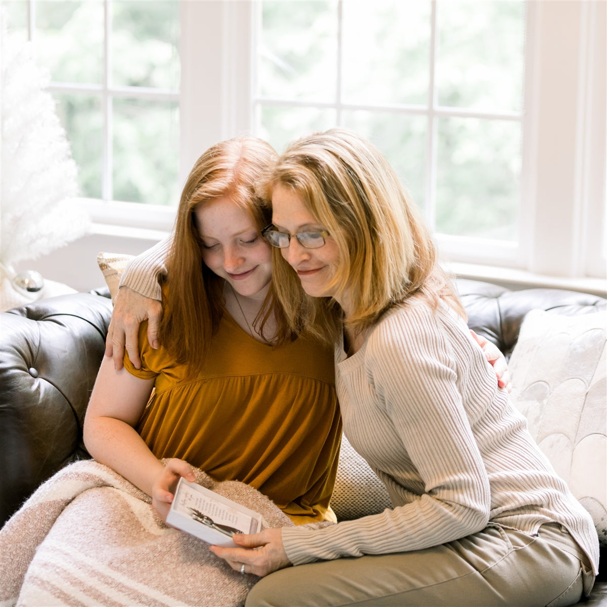 Two women exchanging the Christmas Wishes angel.