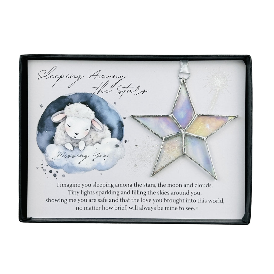 Handmade 4" clear iridescent stained glass star with silver edging, packaged with "Sleeping Among the Stars" sentiment in black gift box with clear lid.